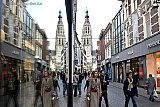 16-12-2025 Breda - Mensen zijn druk bezig met het doen van hun kerstinkopen. Slechts een enkeling ziet 2 torens van de Grote of Onze Lieve Vrouwekerk in het straatbeeld. - Fotokrant